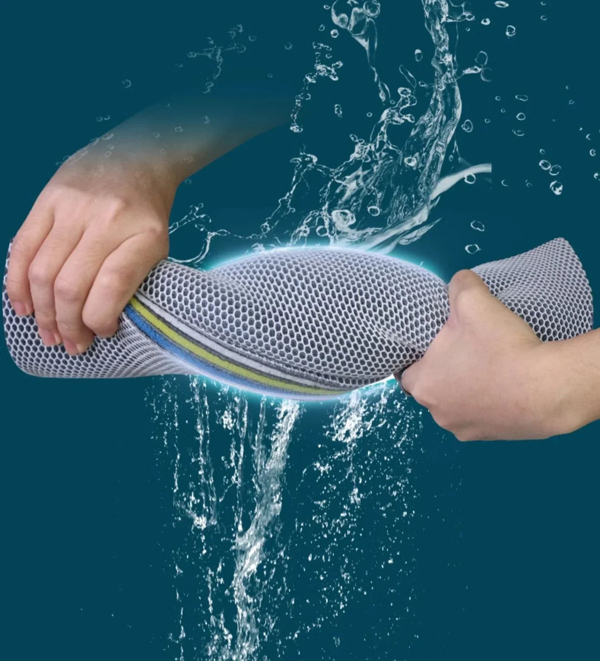 A hand is holding a piece of aquarium sponge filter media that emits a bright blue glow amidst splashing water.