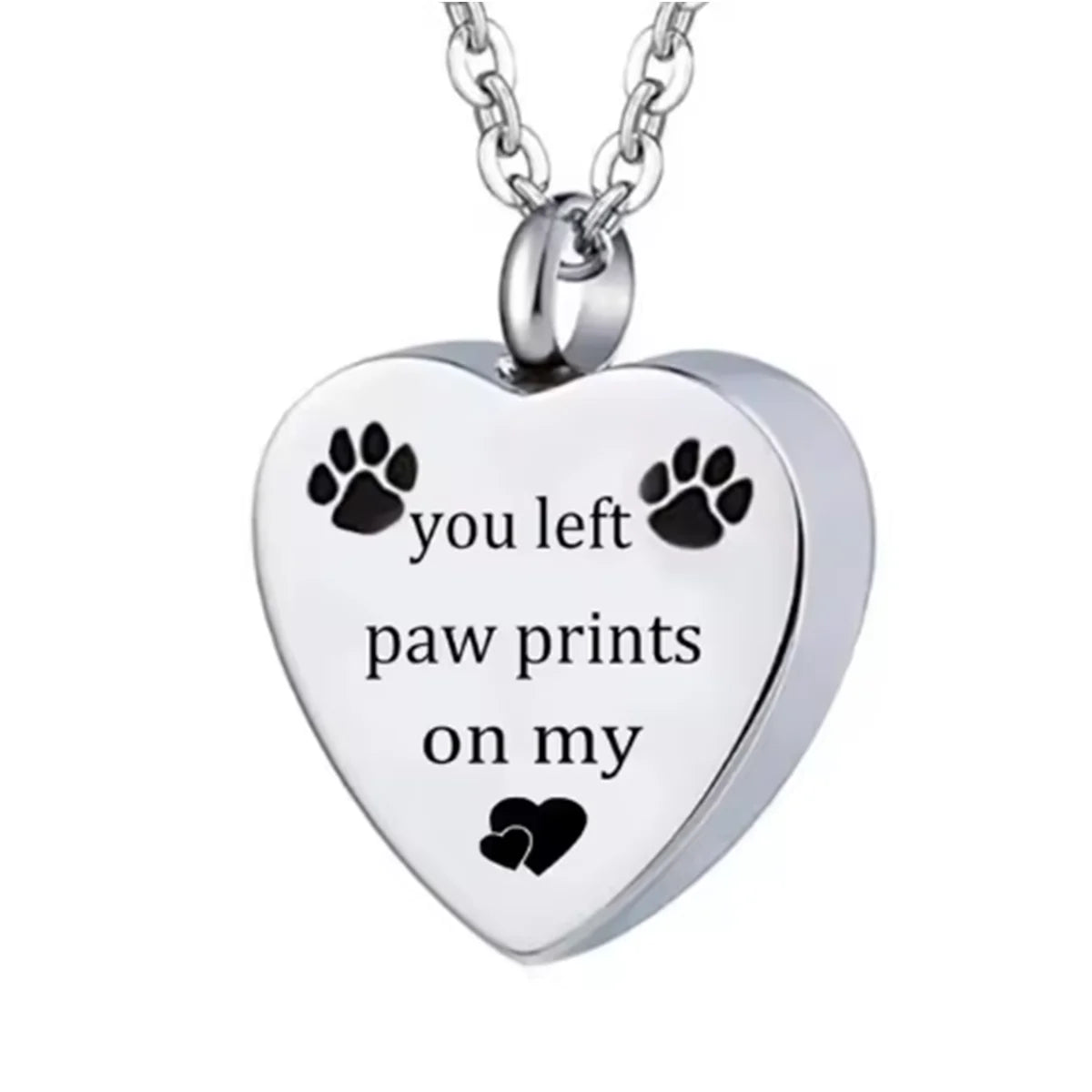 A silver stainless steel pet memorial necklace with a heart pendant engraved with the words you left paw prints on my