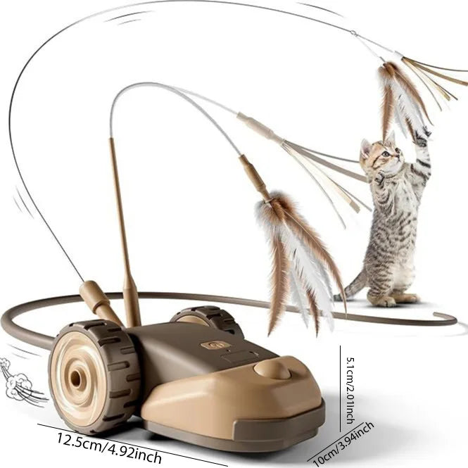 A gray tabby kitten is playing with an interactive moving cat toy car and feather wand.