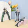 A collection of stainless steel pet nail clippers for dogs and cats in various shades of gray and green resting on a light su