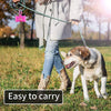A person is walking a dog on a leash, demonstrating the easy to carry reusable pet poop bag dispenser.