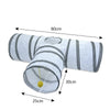 A white collapsible indoor play tunnel for cats with gray stripes and a yellow ball.