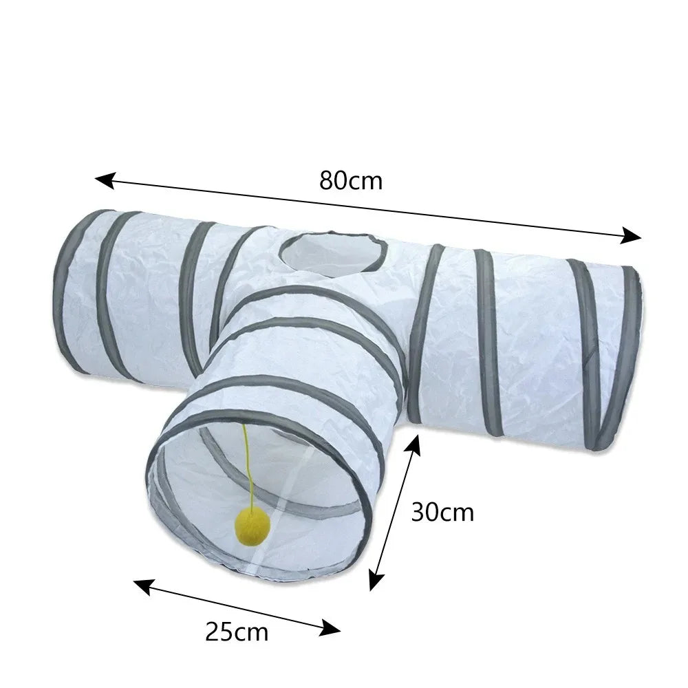 A white collapsible indoor play tunnel for cats with gray stripes and a yellow ball.