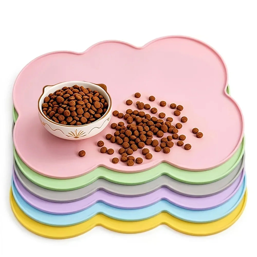 Pink silicone pet feeding mat with raised edges holding brown pet food pellets