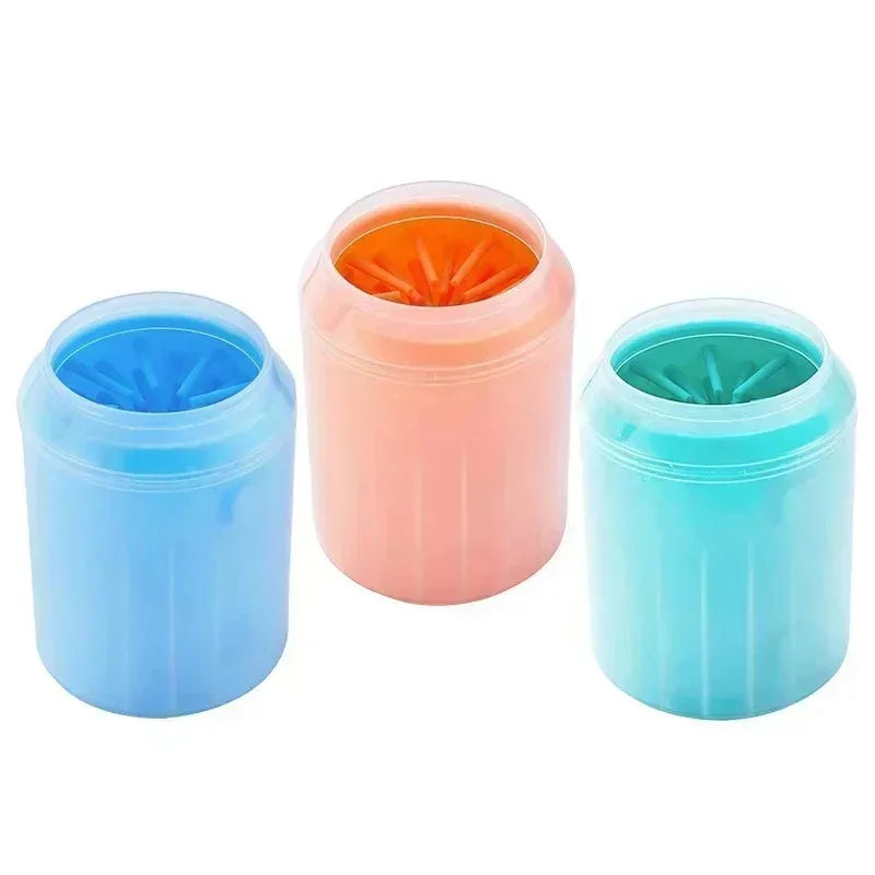 Three silicone cups for pet washing in blue, pink, and teal colors with orange bristles