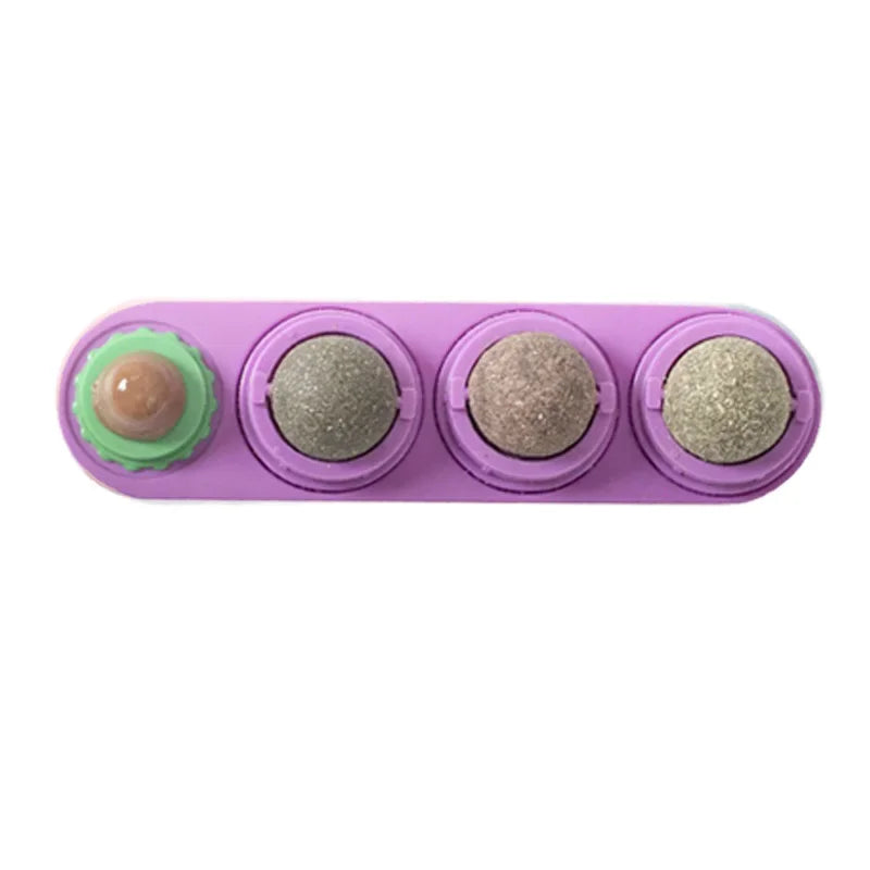 A purple plastic toy with four rotating balls, including a light brown ball.