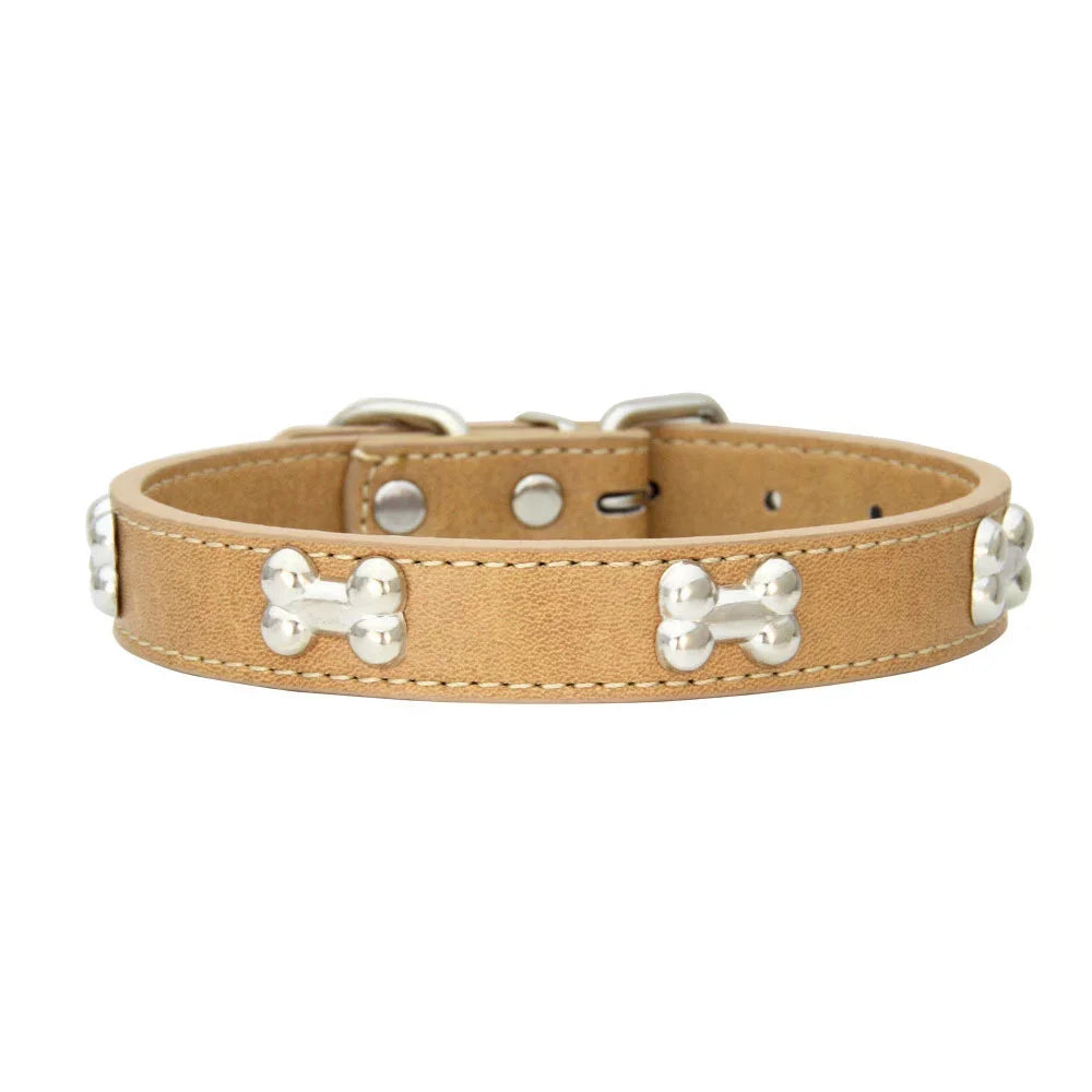 Tan leather dog collar with silver bone rivets and a padded neck strap.