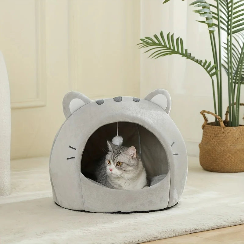 A gray plush tent house shaped like a cat cave with an entrance for a small pet.