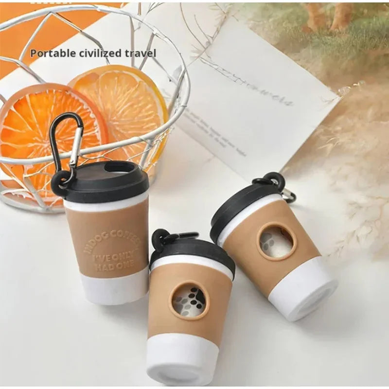 A portable pet poop trash can dispenser in beige and white is shown next to an orange fruit and a wire basket.