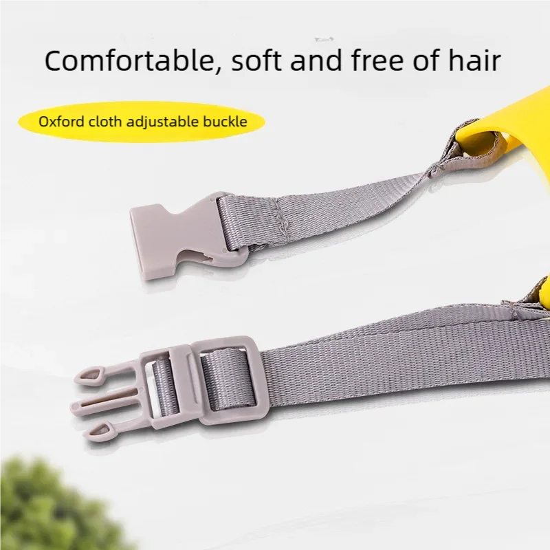 Close-up view of a light gray silicone duck-shaped dog muzzle with an adjustable buckle and yellow strap.