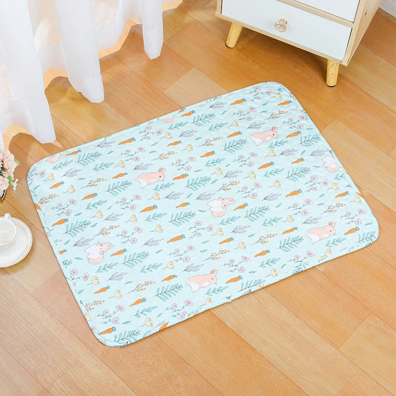 A light blue mat featuring a pattern of pink rabbits and green foliage on a wooden floor.