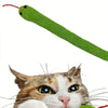 A cat is interacting with a green crinkle toy that resembles a long, flexible green tube.
