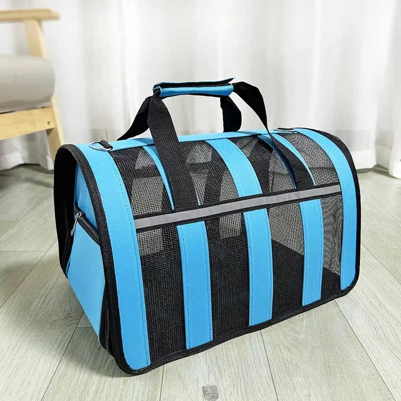 A light blue and black mesh travel carrier bag with a handle is shown on a wooden floor.