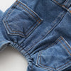 Close-up of a denim dog jumpsuit costume showing stitching and a brand tag.