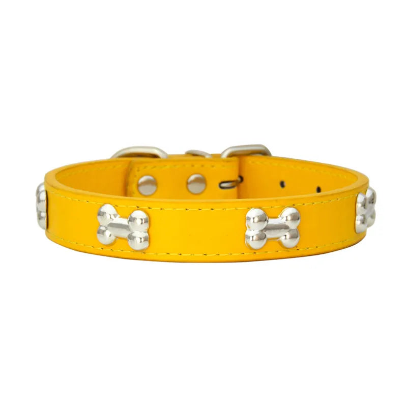 A yellow leather dog collar with silver hardware.