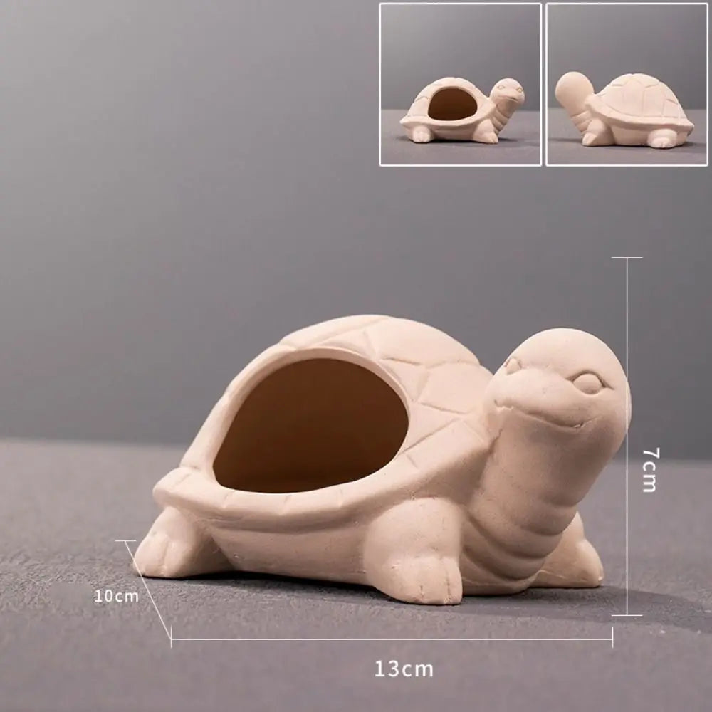 A light beige ceramic aquarium shrimp hideaway cave with a rounded shell and visible interior.