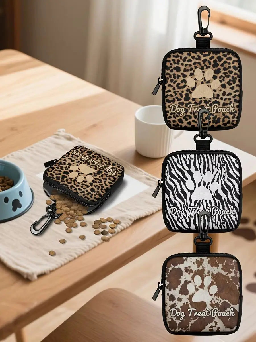 A set of three leather pet treat pouches featuring a leopard print design with paw prints, displayed on a wooden table.