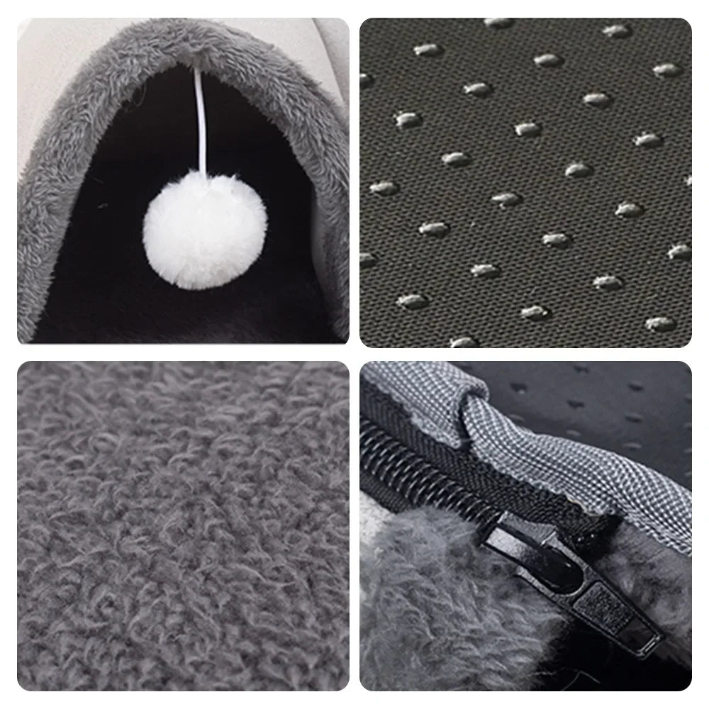 A close-up view of a gray cat tunnel and cozy bed nest featuring a fluffy white pom-pom.