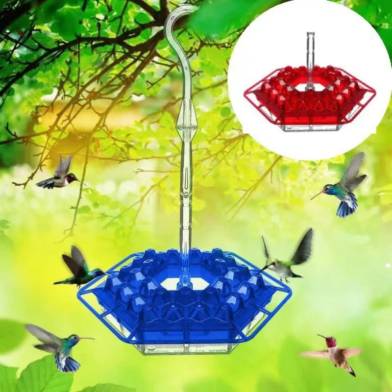 A hummingbird feeder with a hanging hook is shown, featuring a blue and red design, suspended from a tree branch.