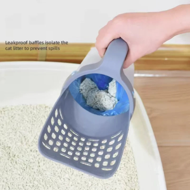 A hand is using a gray self-cleaning cat litter scoop with a filter to isolate cat litter from a white surface.