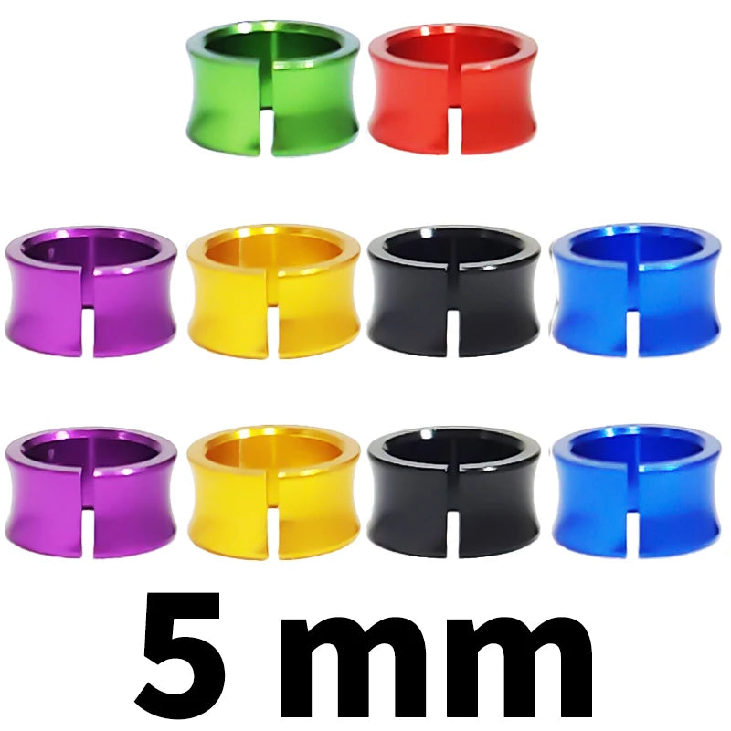Assorted metal bird identification rings in green, red, purple, yellow, black, and blue.