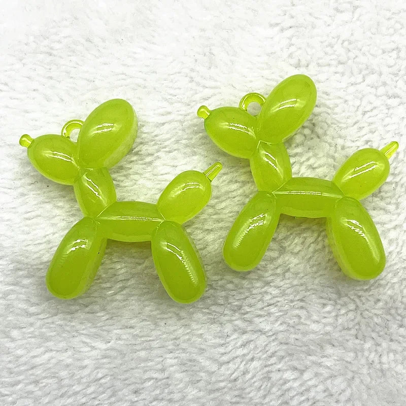 A set of bright lime green acrylic balloon dog charms for jewelry making and keychains