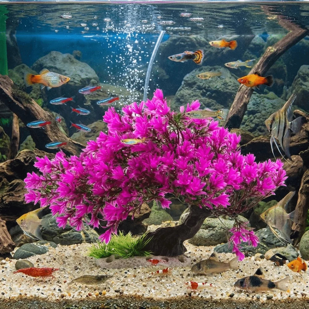 Lifelike artificial aquarium plant shaped like a vibrant pink pine tree in an underwater display.