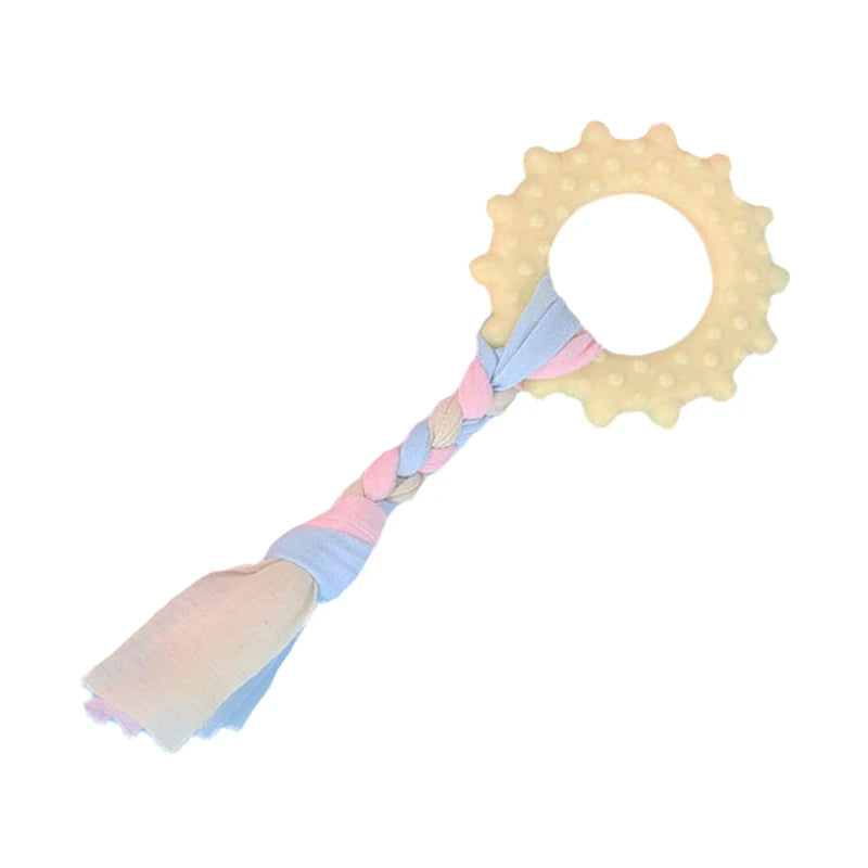 Pink rubber chew toy for small dogs featuring a dental cleaning texture and a circular shape.
