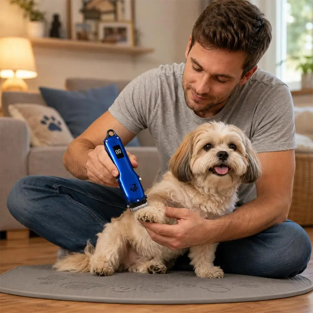 A man is using a blue pet hair clipper grooming kit on a small dog.
