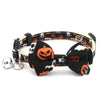 Black and white patterned Halloween pet collar with an orange pumpkin bow tie and a silver bell.