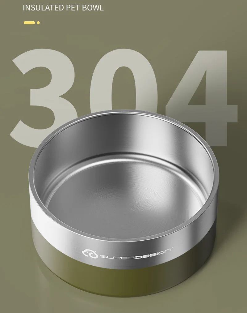 A silver stainless steel insulated pet bowl with a green base is shown against a muted background.