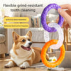A hand holds a purple and orange TPR pull ring dog chew toy, designed for tooth cleaning and interactive play.