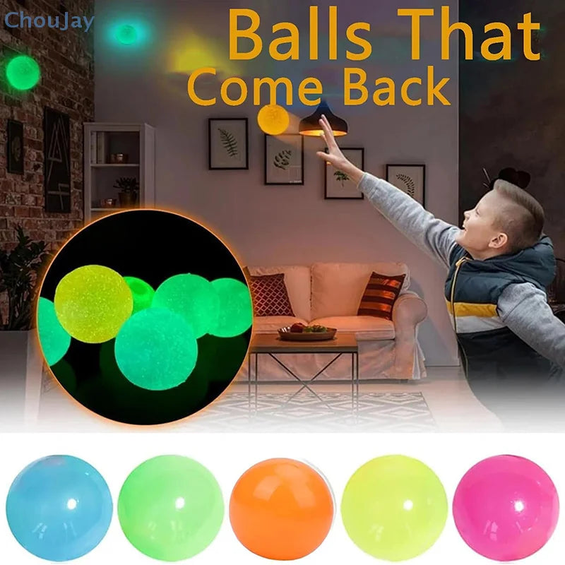 A collection of brightly colored glow-in-the-dark balls, including blue, green, orange, yellow, and pink, are displayed in a 