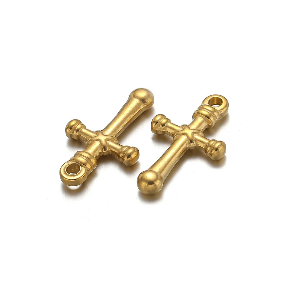 A pair of vintage gold-toned cross charms used for DIY jewelry making.