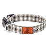 A plaid polyester dog collar with a leather patch and buckle is shown against a white background.