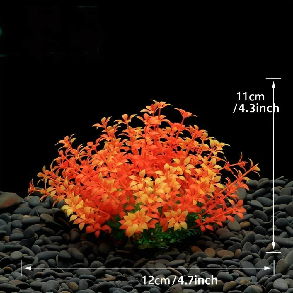A cluster of bright orange artificial aquarium plants on black gravel, with a scale indicating 11 cm in height.