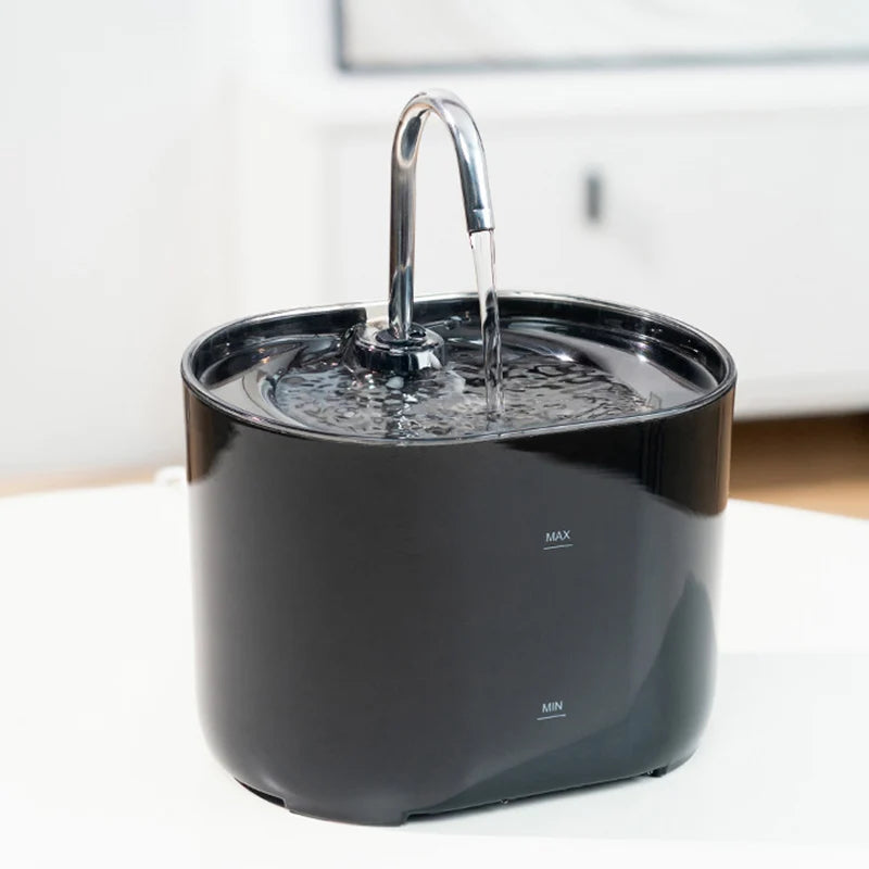 A black cat water fountain with a stainless steel faucet is shown on a white surface.