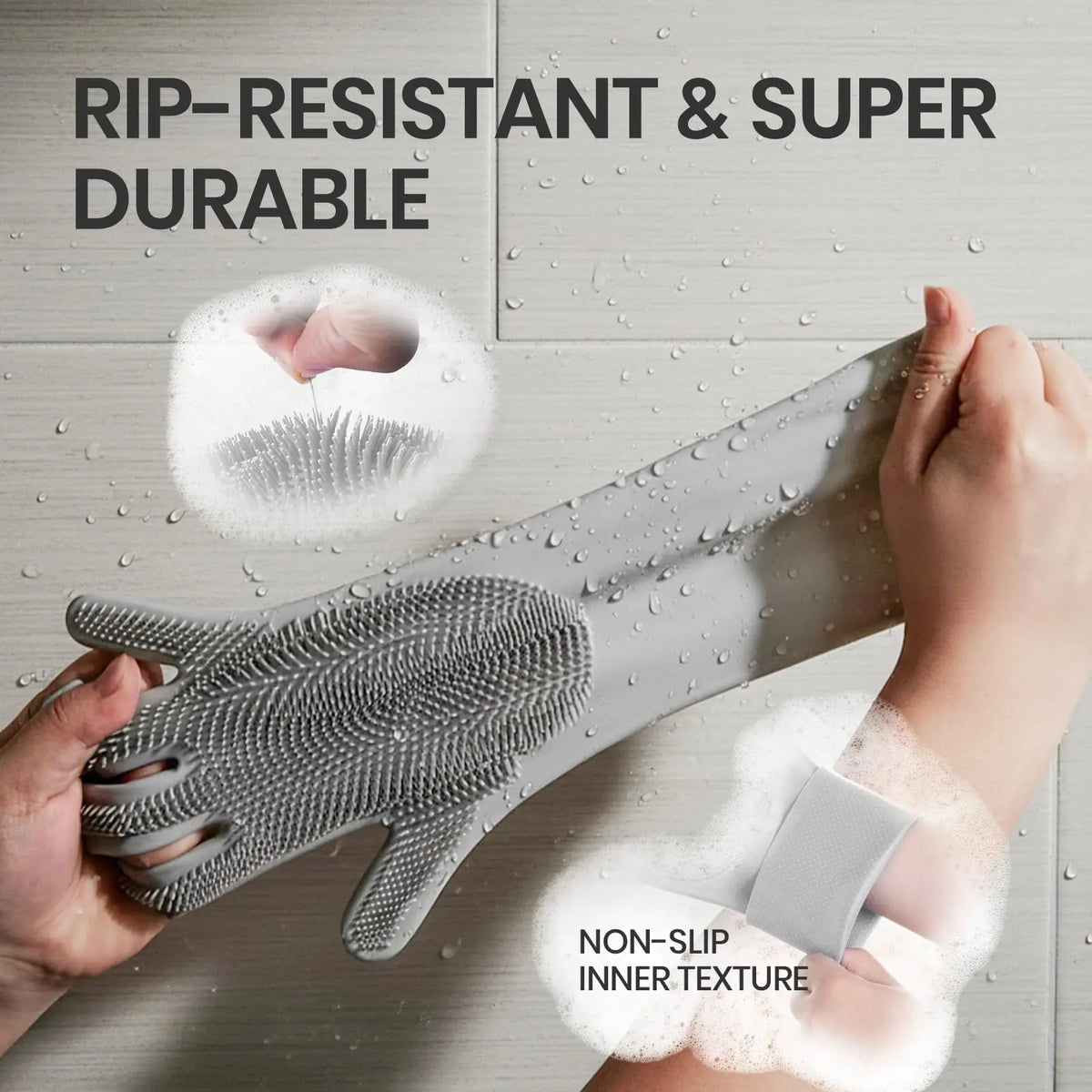 A hand is holding a gray silicone pet grooming glove, showing its textured surface and non-slip inner texture.