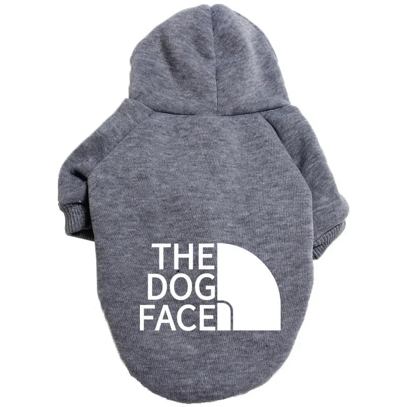 A gray cozy fleece pet hoodie with the text THE DOG FACE printed on the back.