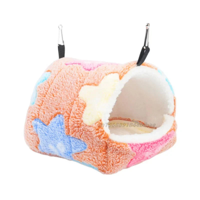 A cozy fleece pet nest bed with pink, white, and blue stars and black hanging loops.