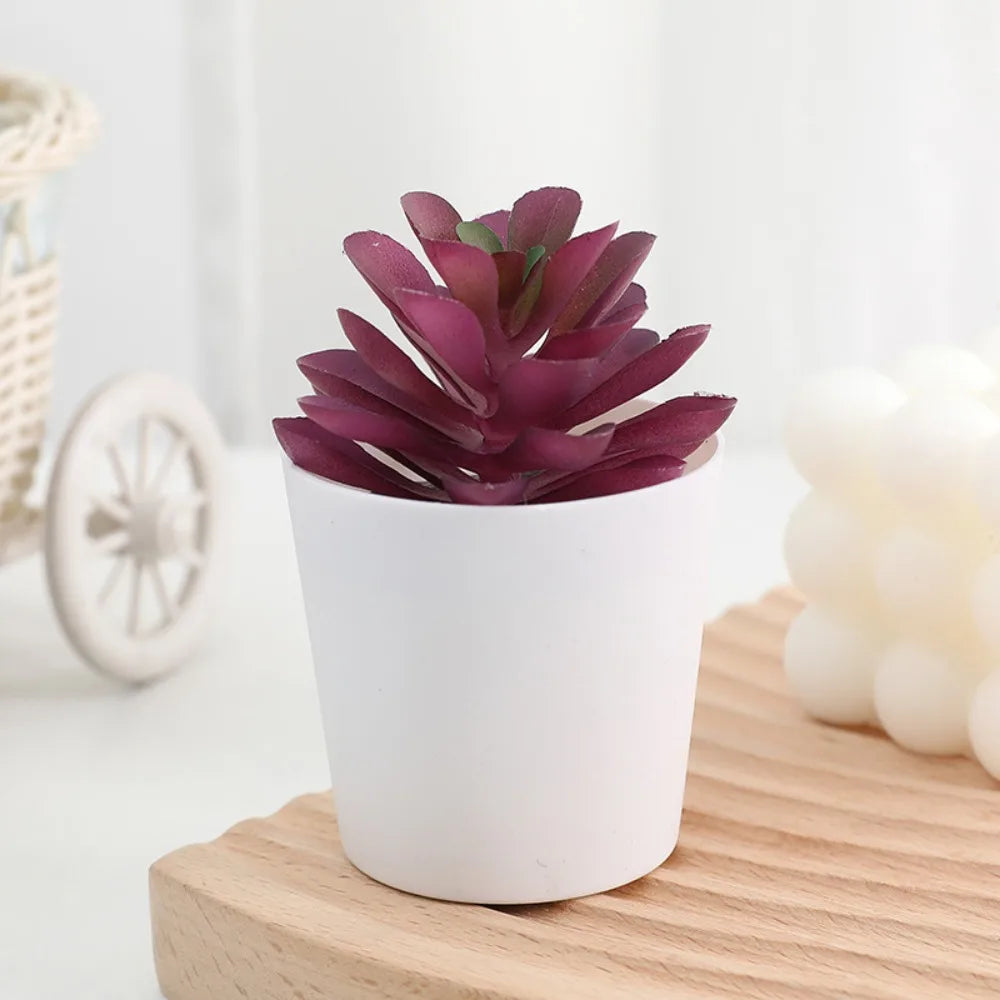 A vibrant purple artificial cactus succulent bonsai plant in a white ceramic pot sitting on a wooden surface.