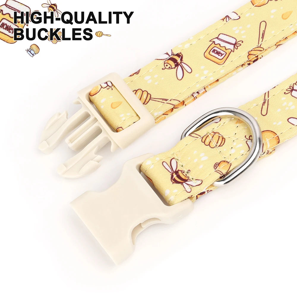 A yellow nylon dog collar with a bee and flower print featuring high-quality buckles.