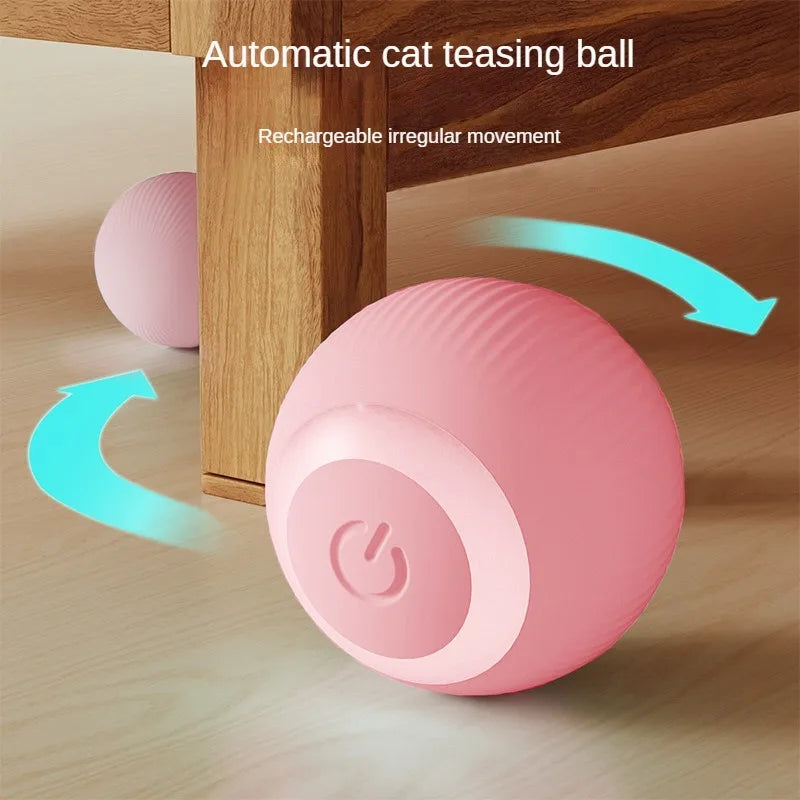 Rosa, automatische Katzen-Spielball rollt auf einer Holzoberfläche mit unregelmäßiger Bewegung.
