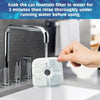 A hand is rinsing a white cat fountain filter under running water in a kitchen sink.