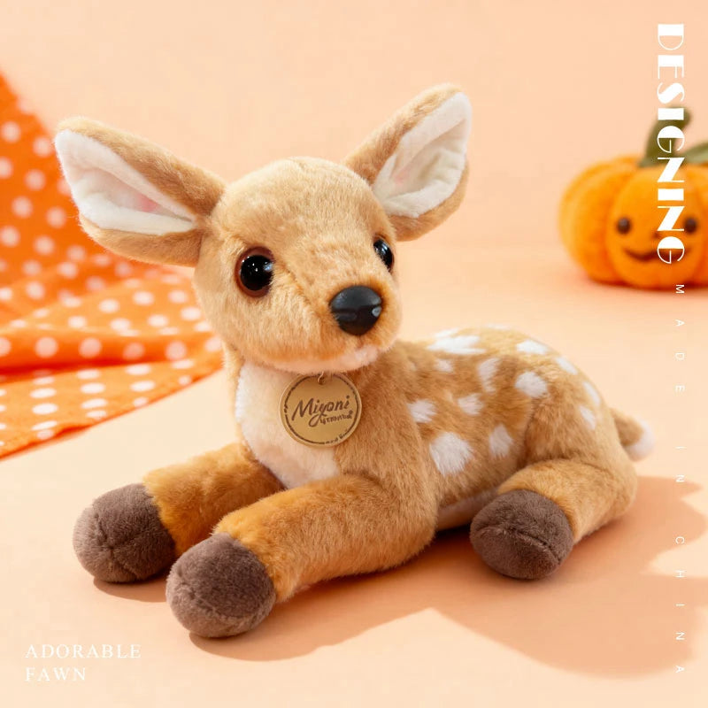A soft plush toy of a fawn-colored deer with large ears and brown paws sitting on a light background.
