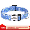 Blue floral print dog collar with a black buckle and white name tag.