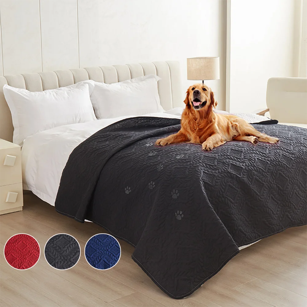 A dark gray waterproof pet bed cover protecting a dog's bedding on a white sofa or mattress.