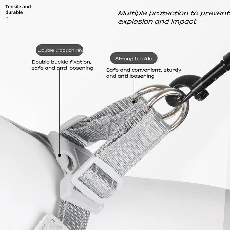 Close-up of a gray reflective mesh pet harness showing double traction rings and a strong buckle mechanism.