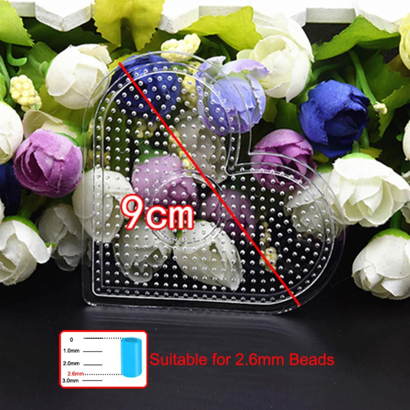 A clear plastic container holding small beads with a 9cm measurement line, suitable for 2.6mm beads.