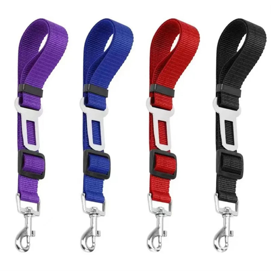 Four adjustable pet car seat belts in purple, blue, red, and black.